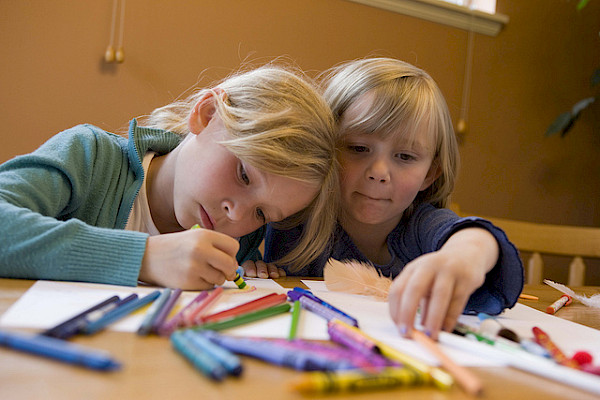 Children drawing with crayons