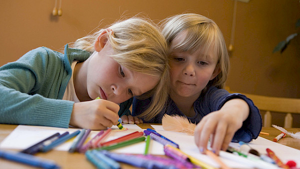 Children drawing with crayons