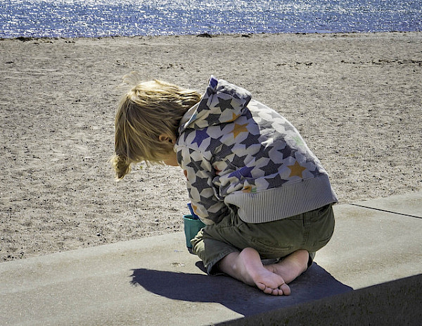 Child playing at the seaside