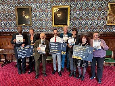 Image of campaigners in parliament campaigning for a railway that is run for people, not profit