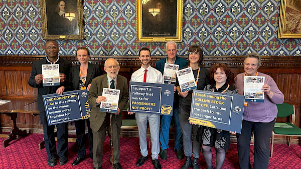 Image of campaigners in parliament campaigning for a railway that is run for people, not profit