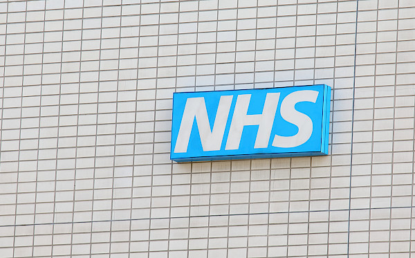 an 'NHS' sign on the side of a building