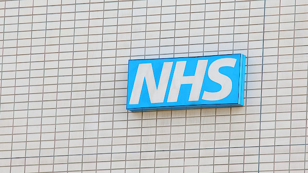 an 'NHS' sign on the side of a building
