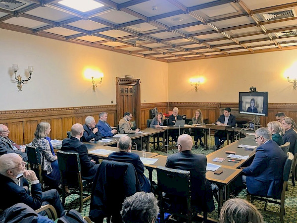 Image of evening in parliament, including campaigners and MPs