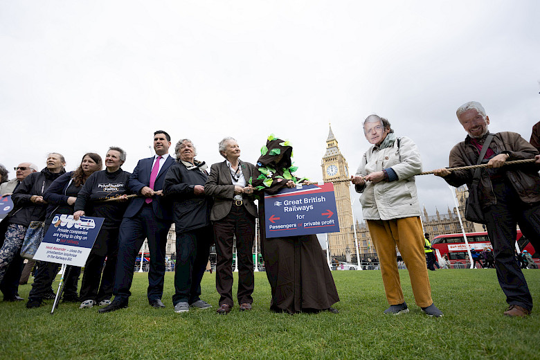 Image of campaigners, MPs taking action in Parliament Square demanding the government make sure the Railways Bill delivers for passengers, not profit