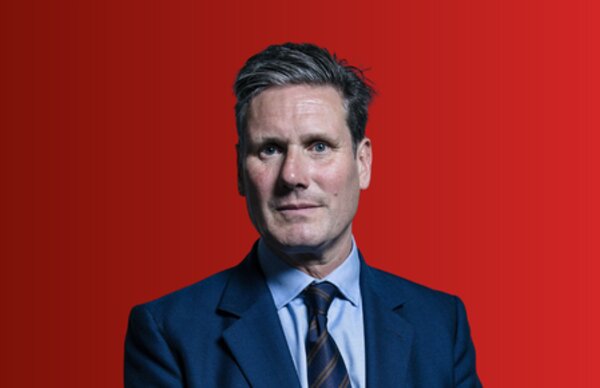 Photo of Starmer on a red background.