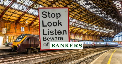 Photo of train station and sign: Stop, look, listen. Beware of bankers