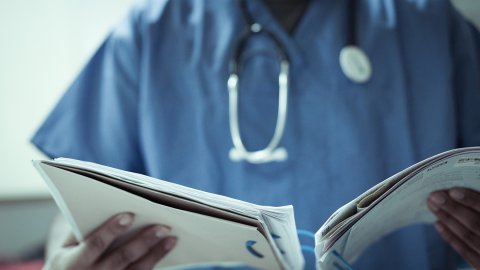 Image of a doctor reading notes