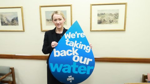 Rebecca Long-Bailey holding a placard in the shape of a water drop which reads: 'Let's take back our water'
