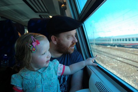 Photo of parent and child on train