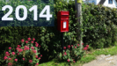 Image of a Royal Mail postbox in a hedgerow