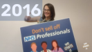 Image of Ellen holding a We Own It poster which says "Don't sell off NHS Professionals"