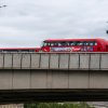 Photo of two red London buses crossing bridge.