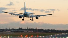 Image of plane landing at dusk