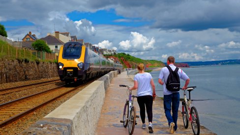 Walking with bikes by a train