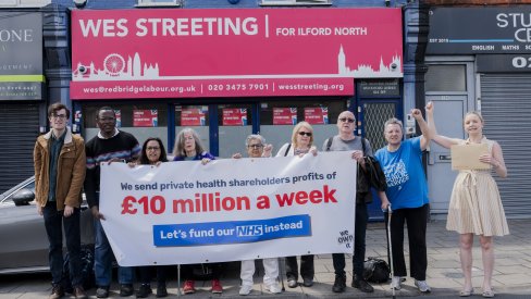 Campaigners at Wes Streeting's office with banner that reads "We lose £10 million a week in private profits from the NHS"